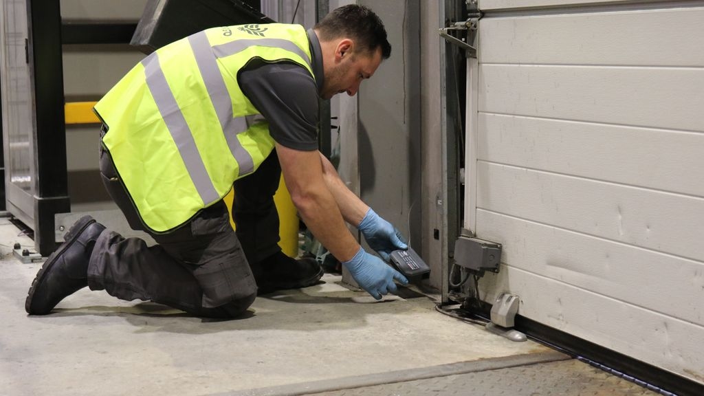 Contego technician placing a rat box in a customer warehouse.