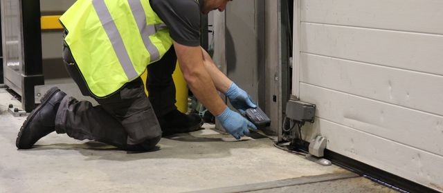 Contego technician placing a rat box in a customer warehouse.