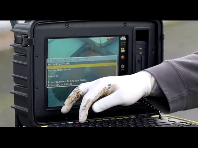 An employee using the drain surveillance equipment