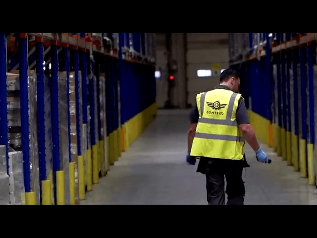 A technician inspecting a facility for pests