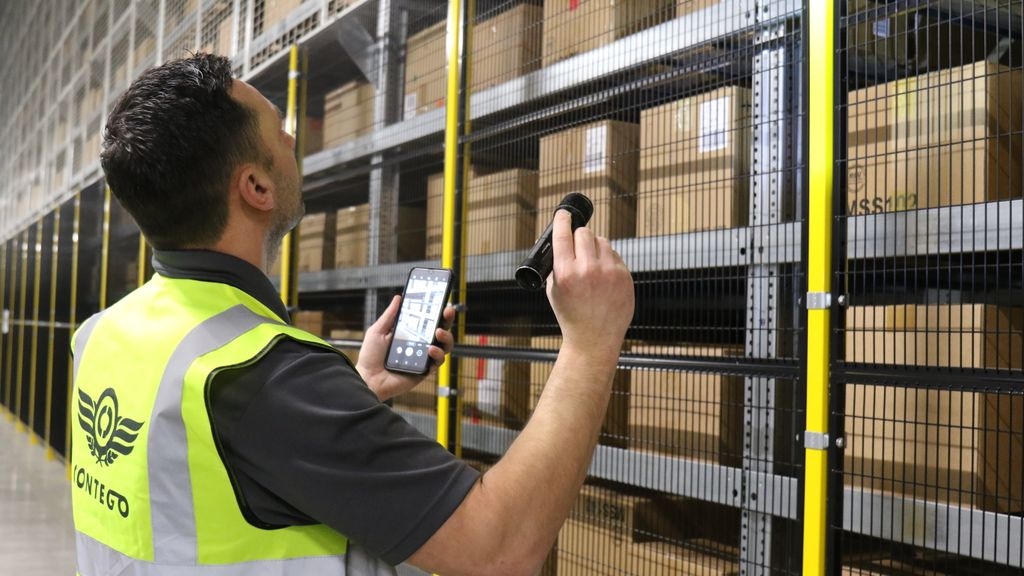 Technician holding phone and torch