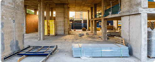 The interior of a construction site with plasterboards and tools
